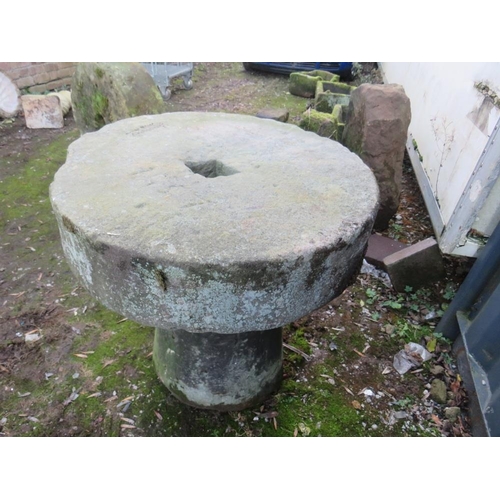 955 - AN ANTIQUE SANDSTONE MILL STONE ON STAND, H 73 cm