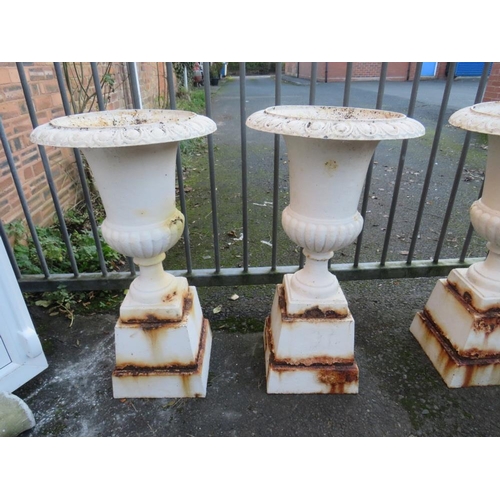 958 - A SET OF FOUR WHITE PAINTED CAST URNS ON STANDS, H 89 cm (4)