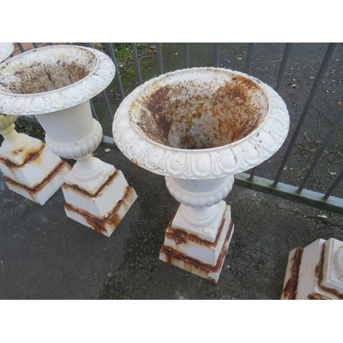 958 - A SET OF FOUR WHITE PAINTED CAST URNS ON STANDS, H 89 cm (4)