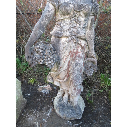 963 - A LARGE STONE STATUE OF A LADY WITH A BASKET OF FRUIT IN HER LEFT HAND, H 152 cm (Note - Heavy)