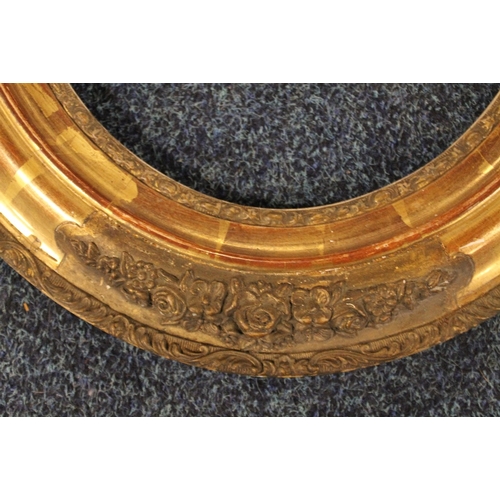 36 - A 19TH CENTURY DECORATIVE OVAL GOLD FRAME, frame W 7.5 cm, site size 30 x 24 cm, rebate 31.5 x 28 cm