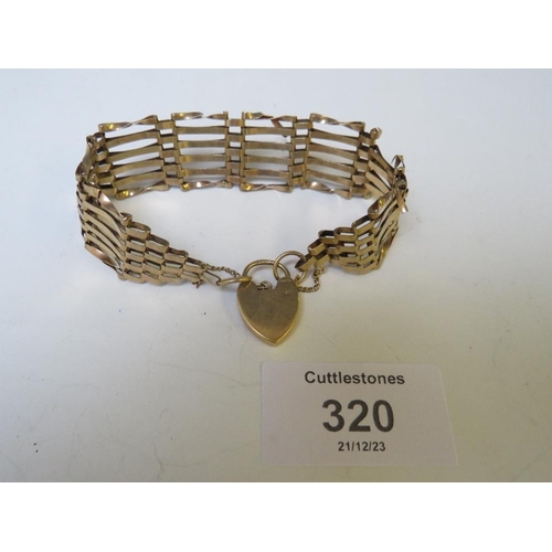 320 - A 9CT GOLD SIX BAR GATE BRACELET, WITH HEART PADLOCK CLASP A/F, APPROX WEIGHT 13.69 G