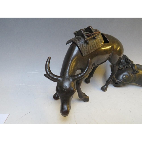 542 - A BRONZE ORIENTAL CENSOR, modelled as an ox with removable saddle, L 22 cm, together with a Buddha o... 