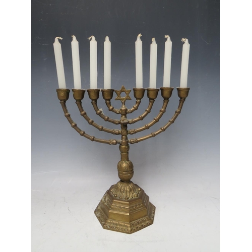 70 - A BRASS EIGHT BRANCH MENORAH CANDLESTICK, raised on an octagonal base, H 24 cm