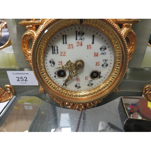 252 - A GILT FIGURAL DECORATIVE MANTLE CLOCK WITH VARIEGATED ONYX BASED , THE FIGURAL SURMOUNT WITH LAMP C... 