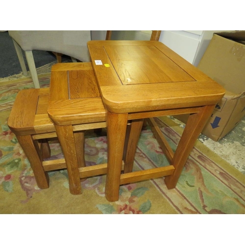 812 - A MODERN OAK NEST OF TABLES