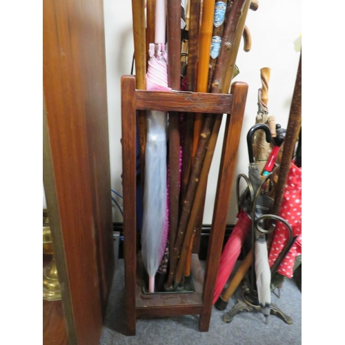 221 - TWO VINTAGE UMBRELLA / STICK STANDS FILLED WITH WALKING STICKS AND UMBRELLAS TO INCLUDE A DISNEY EXA... 