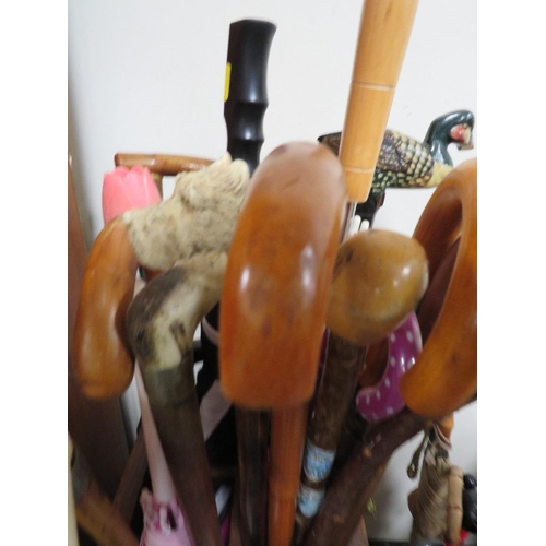 221 - TWO VINTAGE UMBRELLA / STICK STANDS FILLED WITH WALKING STICKS AND UMBRELLAS TO INCLUDE A DISNEY EXA... 