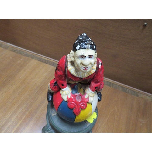 236 - A CAST METAL NOVELTY MONEY BANK IN THE FORM OF A CLOWN ON A BALL