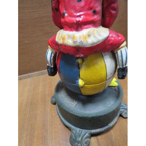 236 - A CAST METAL NOVELTY MONEY BANK IN THE FORM OF A CLOWN ON A BALL