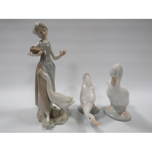 303 - LLADRO LADY AND GOOSE FIGURINE A/F (LADY HAS FINGER MISSING) TOGETHER WITH TWO NAO GOOSE FIGURINE (3... 