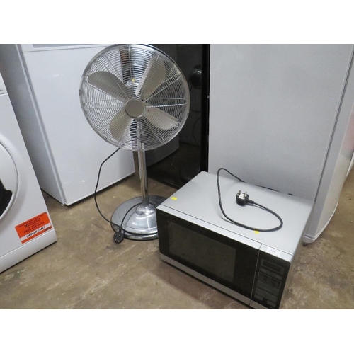 628 - A SHARP MICROWAVE AND A FLOORSTANDING FAN