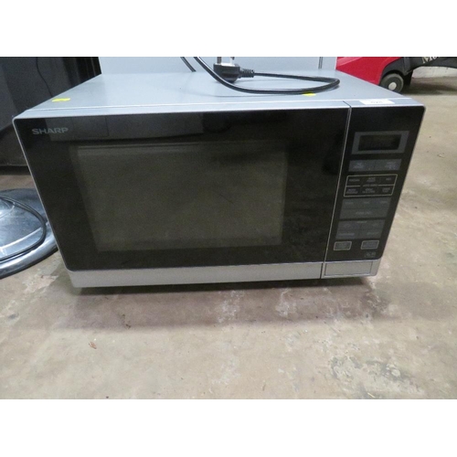 628 - A SHARP MICROWAVE AND A FLOORSTANDING FAN