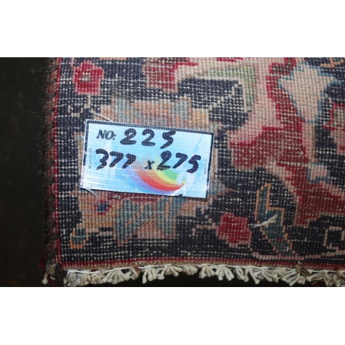 829 - A LARGE EASTERN WOOLLEN RUG IN MAINLY RED AND BLACK PATTERN 377 x 275 cm