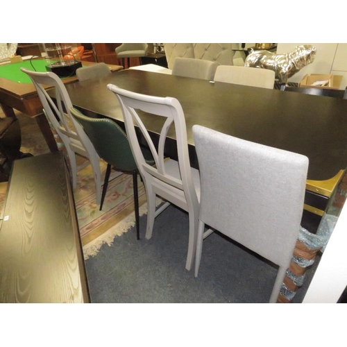 810 - A LARGE BLACK DINING TABLE WITH AN ASSORTMENT OF EIGHT CHAIRS