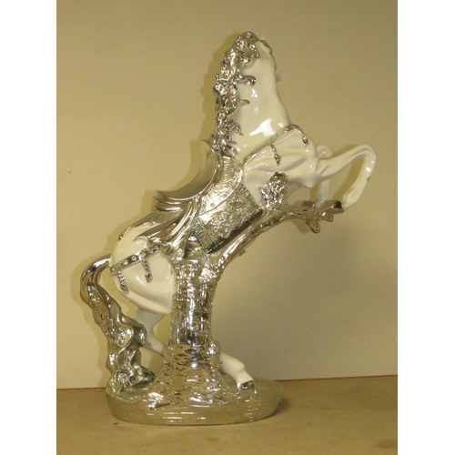 204 - A DECORATIVE SILVER AND WHITE REARING HORSE MODEL