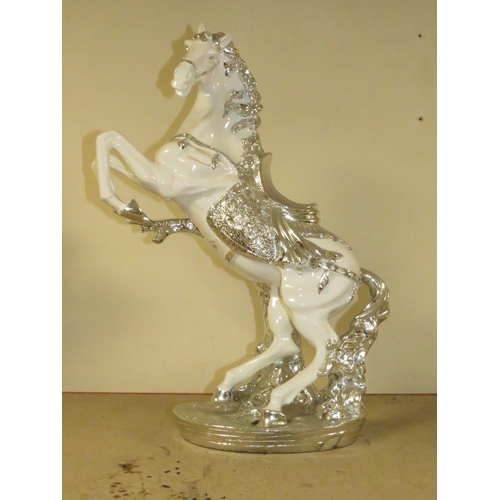 205 - A DECORATIVE SILVER AND WHITE REARING HORSE MODEL