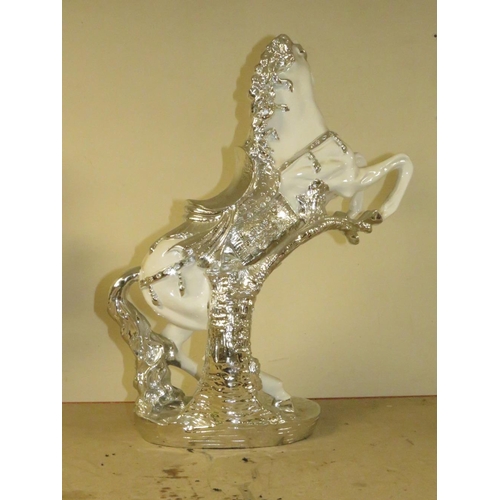 205 - A DECORATIVE SILVER AND WHITE REARING HORSE MODEL