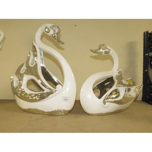 206 - A DECORATIVE PAIR OF SILVER/WHITE SWAN FIGURES