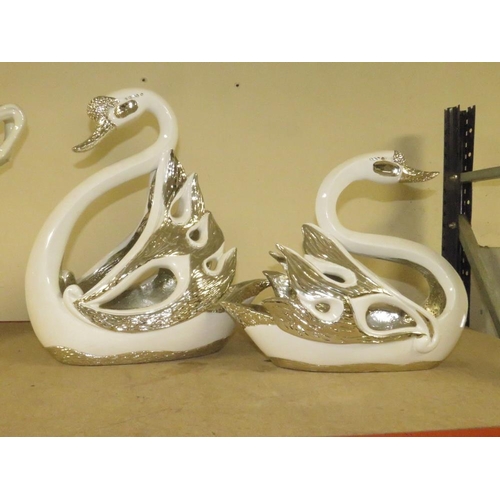 206 - A DECORATIVE PAIR OF SILVER/WHITE SWAN FIGURES