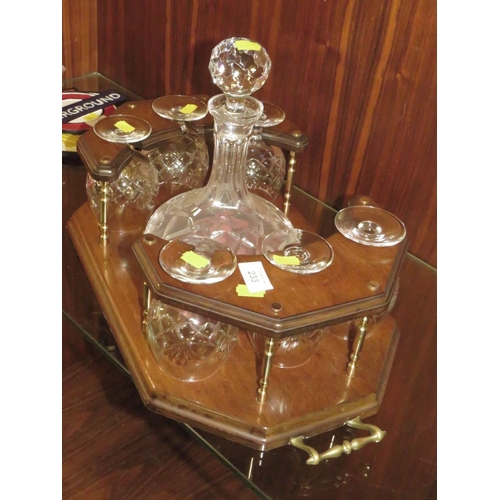 233 - A TWIN HANDLED DRINKS STAND WITH DECANTER AND SIX BRANDY GLASSES