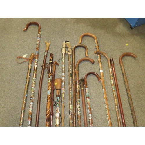 235 - A SELECTION OF WALKING STAFFS WITH BADGES