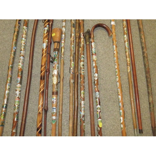 235 - A SELECTION OF WALKING STAFFS WITH BADGES