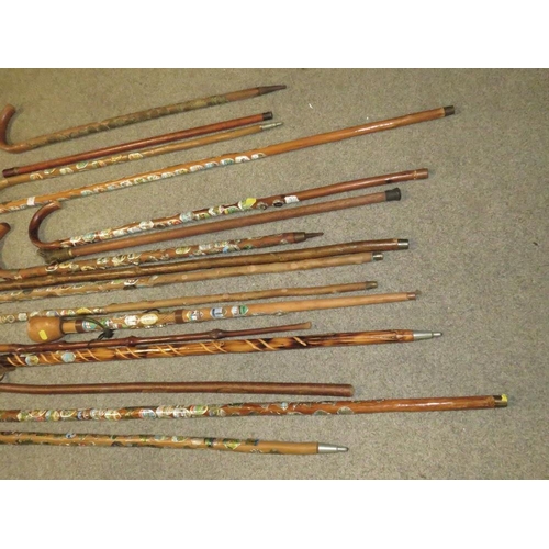 235 - A SELECTION OF WALKING STAFFS WITH BADGES