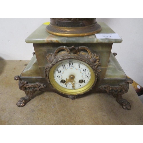 252 - A FIGURAL CLOCK ON ONYX AND GILT METAL BASE