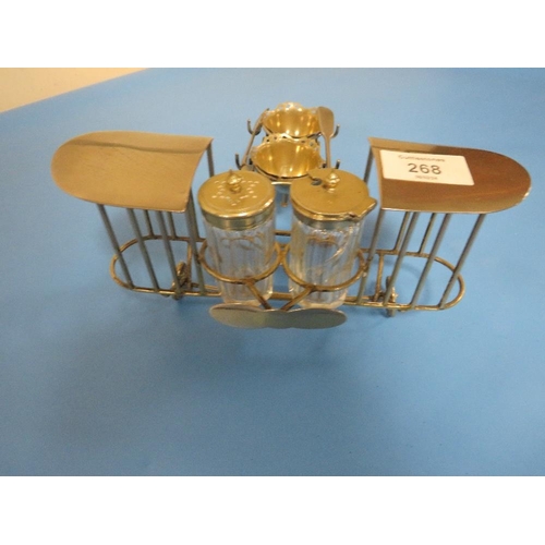 268 - A NOVELTY WIRE WORK CRUET AND EGG CUP STAND IN THE FORM OF A BI PLANE , EGG CUP HAS NO BASE