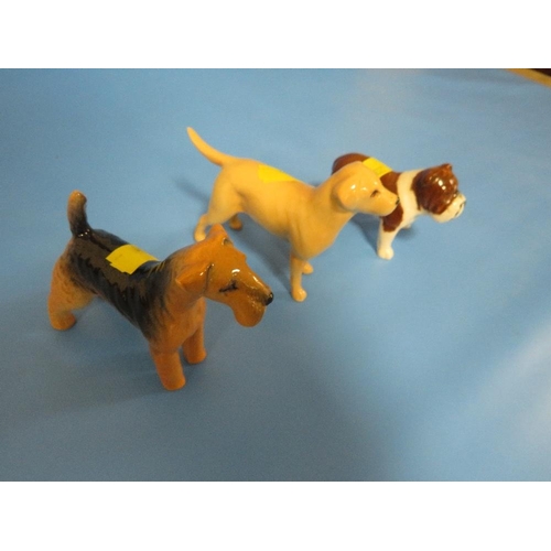 310 - THREE SMALL BESWICK DOGS