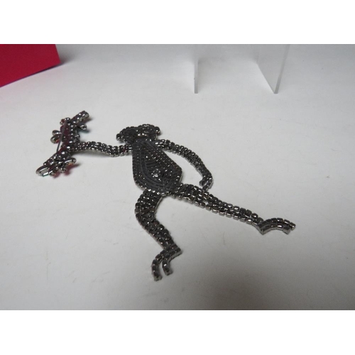 431 - A LARGE BUTLER & WILSON ARTICULATED BROOCH DEPICTING A MONKEY SWINGING FROM A BRANCH,  APPROX DROP 1... 