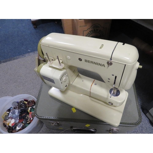 175 - A CASED ELECTRIC BERNINA SEWING MACHINE TOGETHER WITH TWO TUBS OF SEWING ACCESSORIES