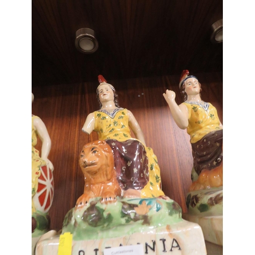 211 - THREE REPRODUCTION STAFFORDSHIRE STYLE FIGURES OF BRITTANIA TOGETHER WITH A MAN PLAYING DRUMS ALL A/... 