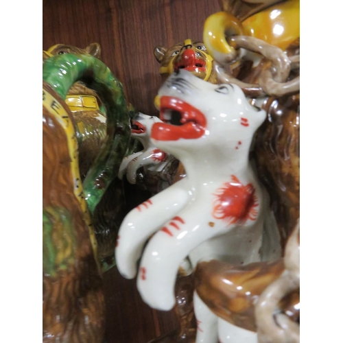 212 - FIVE REPRODUCTION NOVELTY JUGS IN THE FORM OF A CAGE BEAR HOLDING A FELINE