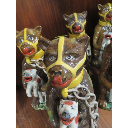 218 - SIX REPRODUCTION NOVELTY JUGS IN THE FORM OF A CAGE BEAR HOLDING A FELINE 