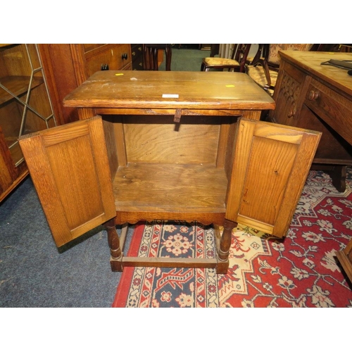 707 - A SMALL OAK GOTHIC TWO DOOR BEDSIDE CUPBOARD