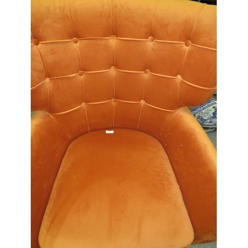 738 - A MODERN BURNT ORANGE UPHOLSTERED ARMCHAIR