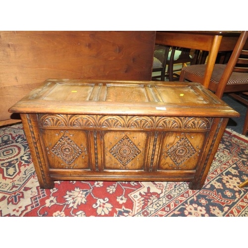 748 - A SMALL OAK CARVED PANELLED COFFER - W 90 cm