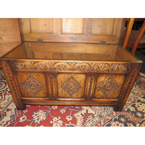 748 - A SMALL OAK CARVED PANELLED COFFER - W 90 cm