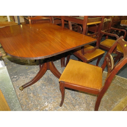 765 - A REPRODUCTION MAHOGANY SHAPED SIDEBOARD WITH A TWIN PEDESTAL TABLE AND EIGHT CHAIRS