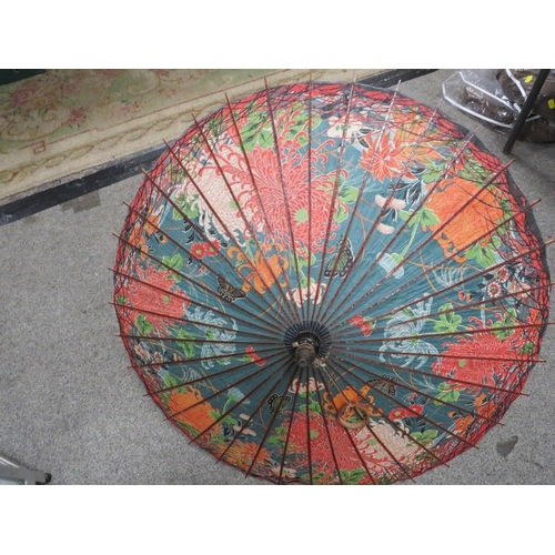 83 - A PAIR OF VINTAGE LAWN BOWLS TOGETHER WITH A SMALL VINTAGE PARASOL