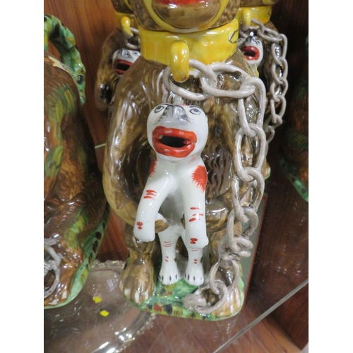 234 - FIVE REPRODUCTION NOVELTY JUGS IN THE FORM OF A CAGE BEAR HOLDING A FELINE 