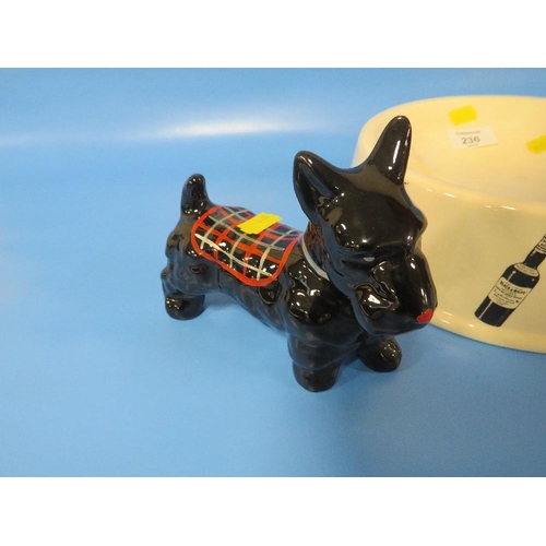 236 - A BLACK AND WHITE WHISKY DOG BOWL TOGETHER WITH A MODEL OF A BLACK SCOTTIE DOG