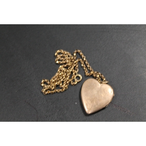 356 - AN ANTIQUE LOCKET AND CHAIN - LOCKET MARKED 9CT BACK AND FRONT