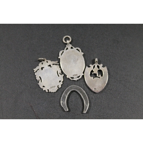 374 - THREE HALLMARKED SILVER FOB MEDALS TOGETHER A BASS METAL MODEL OF A HORSESHOE (4)