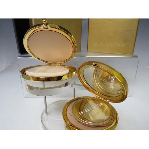 127 - TWO VINTAGE ESTEE LAUDER POWDER COMPACTS, both boxed and with protective cloth 'bags', approx Dia. 6... 