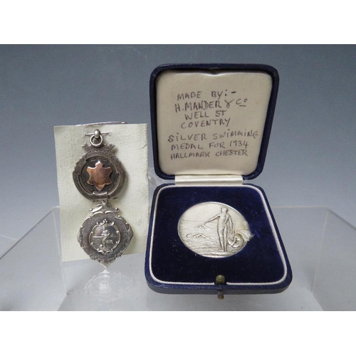 134 - A CASED SILVER SWIMMING MEDAL - CHESTER 1934, together with two hallmarked silver fobs (3)