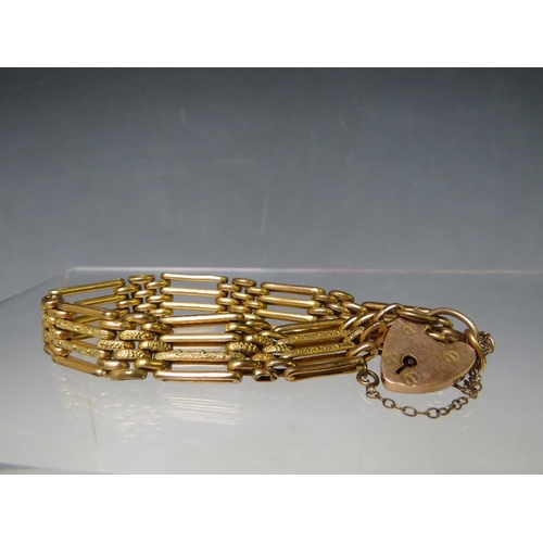 149 - A YELLOW METAL FOUR BAR GATE BRACELET, with heart shaped clasp and safety chain stamped 9ct, having ... 