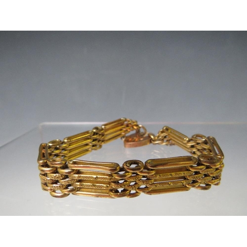 149 - A YELLOW METAL FOUR BAR GATE BRACELET, with heart shaped clasp and safety chain stamped 9ct, having ... 